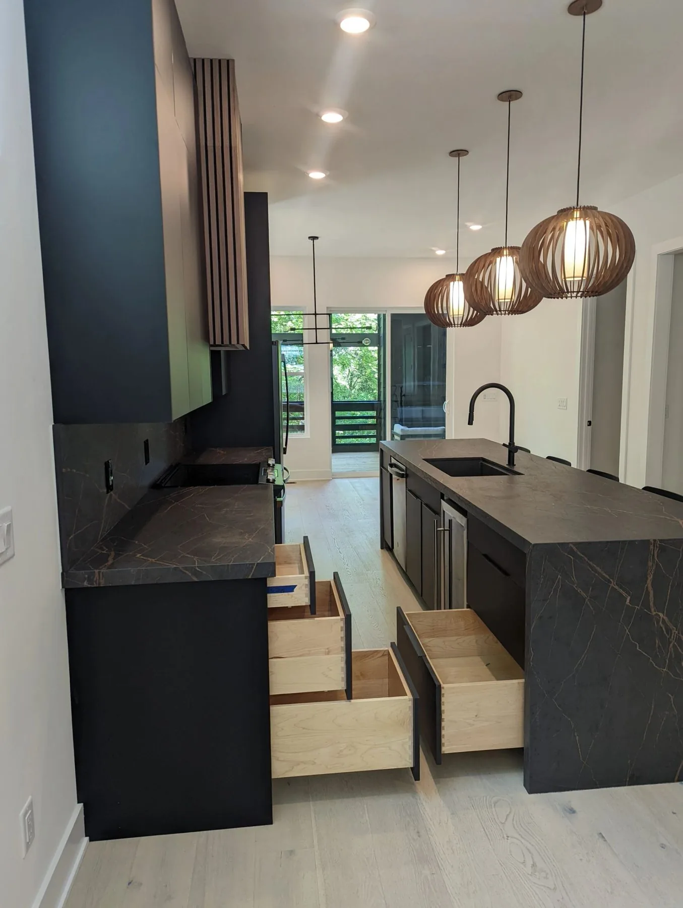 Dark kitchen cabinetry with custom pull-out storage