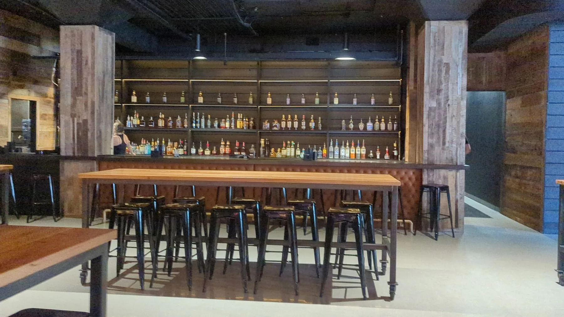 A full commercial bar with custom wood counters and shelving