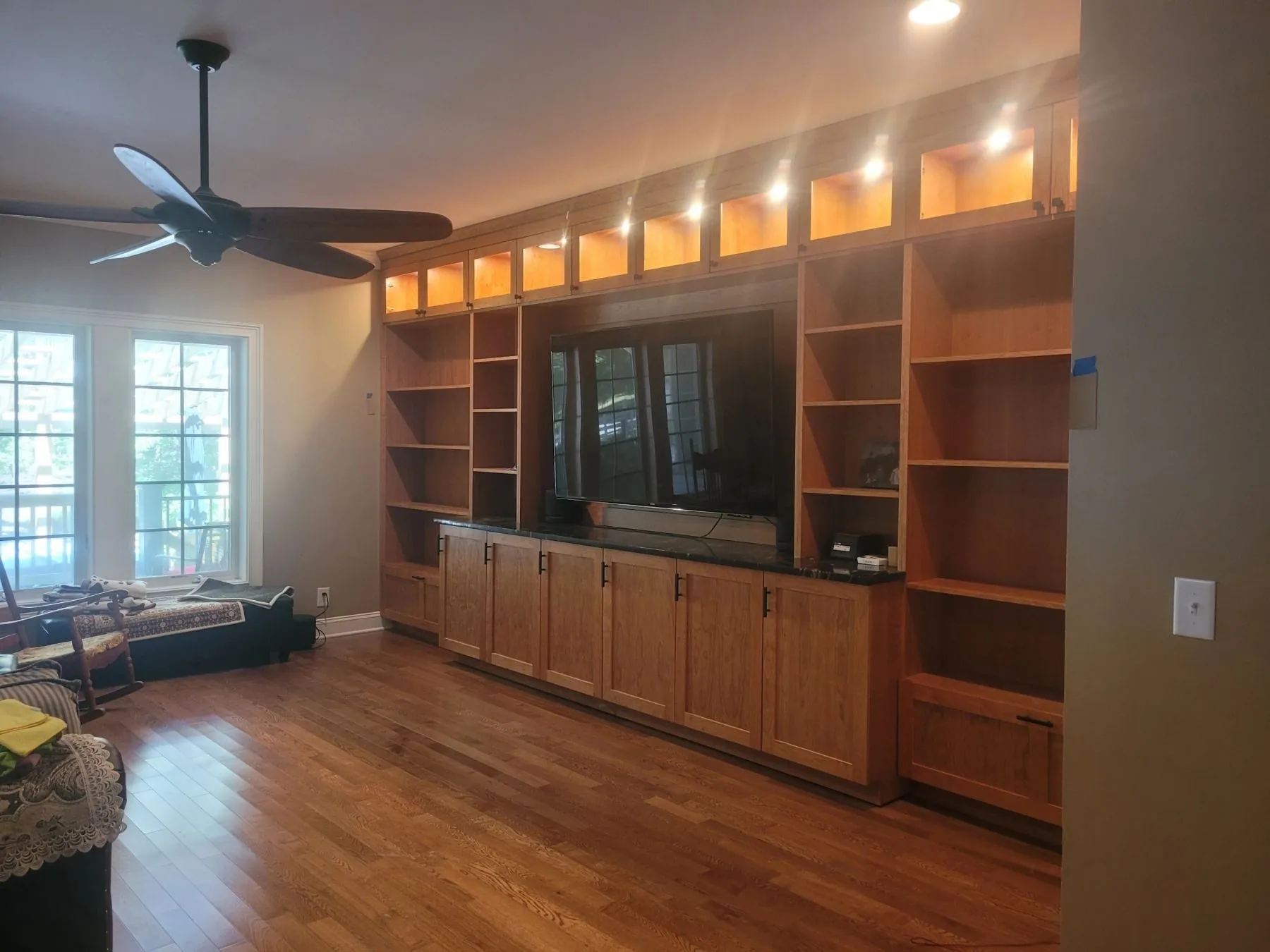A wall-length custom media center with lit display shelving